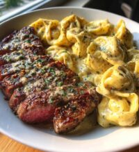 garlic butter steak with cheesy alfredo tortellini